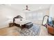 Main bedroom with wood floors, ceiling fan, and large mirror at 4169 Wood Fern Ln, Buford, GA 30519