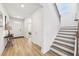 Bright entryway with wood-look floors, leading to staircase and other rooms at 4169 Wood Fern Ln, Buford, GA 30519