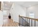 Upstairs hallway with wood-like floors and a view of a TV at 4169 Wood Fern Ln, Buford, GA 30519