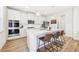 Modern kitchen with white cabinets, stainless steel appliances and breakfast bar at 4169 Wood Fern Ln, Buford, GA 30519