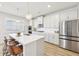 Modern kitchen with white cabinets, stainless steel appliances and breakfast bar at 4169 Wood Fern Ln, Buford, GA 30519