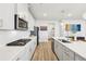 Modern kitchen with white cabinets, stainless steel appliances and breakfast bar at 4169 Wood Fern Ln, Buford, GA 30519