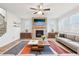 Living room with hardwood floors, fireplace, and open concept design at 4169 Wood Fern Ln, Buford, GA 30519