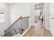 Upstairs hallway with wood-look floors and access to bedrooms at 4169 Wood Fern Ln, Buford, GA 30519