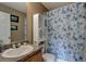 Bathroom with floral shower curtain and small vanity at 9265 Tara Sw Dr, Covington, GA 30014