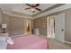 Main bedroom with tray ceiling and access to bathroom at 9265 Tara Sw Dr, Covington, GA 30014