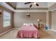 Spacious bedroom with tray ceiling and pink bedding at 9265 Tara Sw Dr, Covington, GA 30014