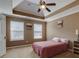 Bedroom with tray ceiling and two windows at 9265 Tara Sw Dr, Covington, GA 30014