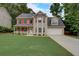 Two story house with red shutters, attached garage, and manicured lawn at 9265 Tara Sw Dr, Covington, GA 30014