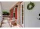 Inviting front porch with white door and red shutters at 9265 Tara Sw Dr, Covington, GA 30014