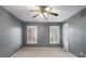 Empty bedroom with neutral paint, carpet, and two windows and closet at 1101 Collier Nw Rd # L3, Atlanta, GA 30318