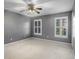 Empty bedroom with neutral paint, carpet, and two windows at 1101 Collier Nw Rd # L3, Atlanta, GA 30318