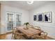 Bright dining area with hardwood floors, glass doors, table and wall art at 1101 Collier Nw Rd # L3, Atlanta, GA 30318