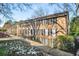 Brick condo building with a symmetrical facade, black shutters, and well-maintained landscaping at 1101 Collier Nw Rd # L3, Atlanta, GA 30318