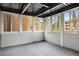 Enclosed sunroom featuring multiple windows offering natural light and neighborhood views at 1101 Collier Nw Rd # L3, Atlanta, GA 30318