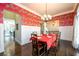 Bright dining room with hardwood floors and red zebra wallpaper at 1939 Ridgemont Ln, Decatur, GA 30033