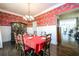 Spacious dining room with hardwood floors and red zebra wallpaper at 1939 Ridgemont Ln, Decatur, GA 30033