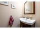 Small half bathroom with a pedestal sink and framed mirror at 1939 Ridgemont Ln, Decatur, GA 30033