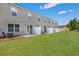 Back exterior view showing multiple townhouses with grassy yards at 2278 Jamin Bnd # 17, Lithonia, GA 30058