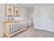 Well-lit Bedroom featuring a crib and wall art at 2278 Jamin Bnd # 17, Lithonia, GA 30058