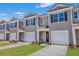 Modern taupe townhouses with attached garages and landscaping at 2278 Jamin Bnd # 17, Lithonia, GA 30058