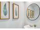 Small powder room with round mirror and leaf art at 2278 Jamin Bnd # 17, Lithonia, GA 30058