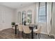 A dining room area with a dining table, four chairs, and natural light from the window at 2280 Jamin Bnd # 17, Lithonia, GA 30058