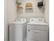 Functional laundry area equipped with modern washer and dryer units, and shelf at 2280 Jamin Bnd # 17, Lithonia, GA 30058