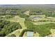 Aerial view of golf course, pond, and tennis courts at 5032 Hickory Hills Dr, Woodstock, GA 30188