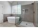 Spa-like bathroom with a large walk-in shower and a free-standing tub at 5032 Hickory Hills Dr, Woodstock, GA 30188