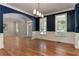 Spacious dining room with hardwood floors, navy walls, and crown molding at 5032 Hickory Hills Dr, Woodstock, GA 30188