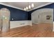 Elegant dining room with hardwood floors, navy walls, and white wainscoting at 5032 Hickory Hills Dr, Woodstock, GA 30188