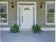 White front door with sidelights and a paw print doormat at 5032 Hickory Hills Dr, Woodstock, GA 30188