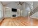 Gathering room with hardwood floors, fireplace and built-in shelving at 5032 Hickory Hills Dr, Woodstock, GA 30188