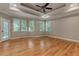 Spacious main bedroom with hardwood floors, tray ceiling, and ample natural light at 5032 Hickory Hills Dr, Woodstock, GA 30188