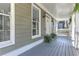 Spacious porch with gray wood floors and potted plants at 5032 Hickory Hills Dr, Woodstock, GA 30188