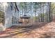 Expansive backyard view featuring the deck and gazebo of a home with manicured landscaping and mature trees at 588 Myrtle Trace Ln, Suwanee, GA 30024