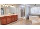 Bathroom with double vanity, soaking tub, and walk-in shower at 588 Myrtle Trace Ln, Suwanee, GA 30024