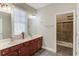 Bathroom with double sink vanity, shower, and tile floor at 588 Myrtle Trace Ln, Suwanee, GA 30024