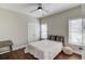 Bedroom with wood floors, ceiling fan, and a queen bed at 588 Myrtle Trace Ln, Suwanee, GA 30024