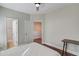 Bedroom showcasing neutral color palette, wood floors, and doorways to a bathroom and hallway at 588 Myrtle Trace Ln, Suwanee, GA 30024