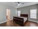 Bedroom showcasing neutral color palette, wood floors, and doorway to a bathroom at 588 Myrtle Trace Ln, Suwanee, GA 30024