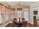 Bright breakfast nook with wood table and chairs, near the kitchen at 588 Myrtle Trace Ln, Suwanee, GA 30024