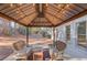 Inviting covered patio featuring a gazebo with hanging string lights and a cozy seating area at 588 Myrtle Trace Ln, Suwanee, GA 30024