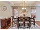 Dining room with hardwood floors, chandelier, and buffet at 588 Myrtle Trace Ln, Suwanee, GA 30024