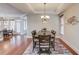 Formal dining room with hardwood floors and chandelier at 588 Myrtle Trace Ln, Suwanee, GA 30024