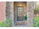 Inviting front door entry with stone accents and welcome mat at 588 Myrtle Trace Ln, Suwanee, GA 30024