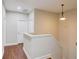 Upstairs hallway with wood floors and neutral walls at 588 Myrtle Trace Ln, Suwanee, GA 30024