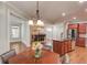 Open-concept kitchen with cherry wood cabinets, stainless steel appliances, and hardwood floors at 588 Myrtle Trace Ln, Suwanee, GA 30024