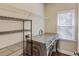 Laundry room with washer, dryer, and ample shelving at 588 Myrtle Trace Ln, Suwanee, GA 30024